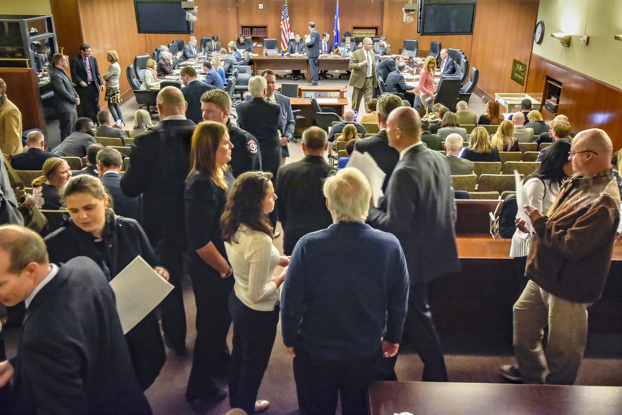 A flurry of activity in the hearing room moments before the House Job Growth and Energy Affordability Policy and Finance Committee convened April 18 for a walk-through of the omnibus job growth and energy affordability finance bill. Photo by Andrew VonBank
